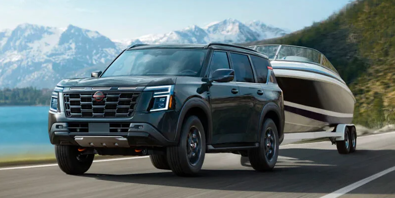 A photo of a 2025 Nissan Armada towing a boat.