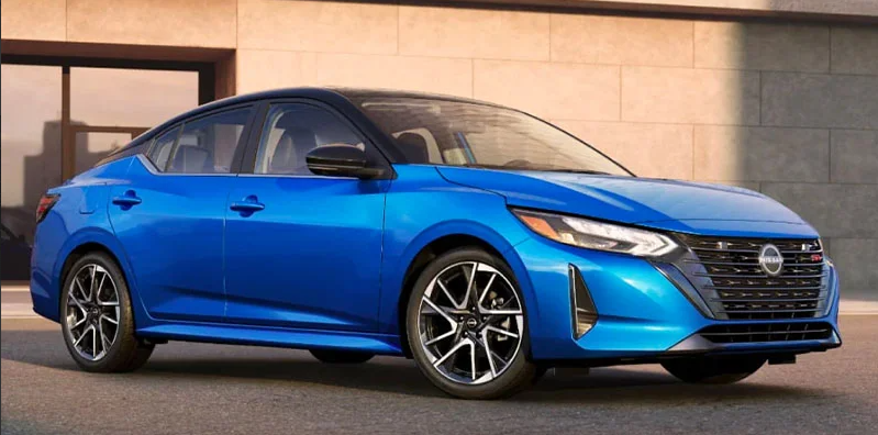 A photo of a blue 2025 Nissan Sentra parked with the passenger side facing the camera.